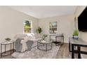 Bright living room features hardwood floors, neutral decor and natural light, creating a comfortable living space at 1419 55Th S St, Gulfport, FL 33707