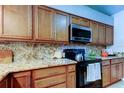 A close view of granite countertops, stove and hardwood cabinets at 2547 Stony Brook Ln, Clearwater, FL 33761