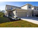 Attractive two-story home boasts a neatly landscaped front yard, and a two-car garage at 3000 Jacob Crossing Ln, Holiday, FL 34691