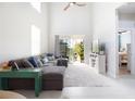 Bright living room featuring a comfortable sofa, tall ceilings, and access to a balcony at 3000 Jacob Crossing Ln, Holiday, FL 34691