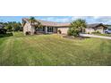 Inviting one-story home featuring a lush green lawn, mature landscaping, and a charming entrance pergola at 3276 Hilary Cir, Palm Harbor, FL 34684