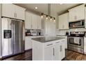 Modern kitchen with stainless steel appliances, an island, and white cabinetry at 33176 Whisper Pointe Dr, Wesley Chapel, FL 33545