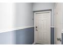 Condo entryway featuring neutral paint scheme with white trim and classic six-panel door at 5003 Starfish Dr Se # B, St Petersburg, FL 33705