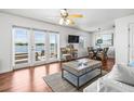 Bright living room with wood floors, water view, and comfortable seating arrangement at 5003 Starfish Dr Se # B, St Petersburg, FL 33705