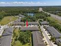 Aerial view showcasing the neighborhood, nearby lake, and easy access to the highway at 6225 Scarlet Darter Way, Tampa, FL 33625