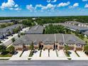 Townhome exterior featuring neutral stucco, a private drive and well-kept landscaping at 6225 Scarlet Darter Way, Tampa, FL 33625