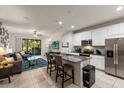 Open-concept kitchen and living area with modern appliances, granite countertops, and backyard access at 6225 Scarlet Darter Way, Tampa, FL 33625