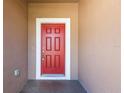 Bright red front door adds a pop of color to the exterior and invites guests into the home at 711 Parker Den Dr, Ruskin, FL 33570