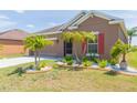 This home's exterior boasts meticulous landscaping with palm trees, offering curb appeal and a welcoming entrance at 711 Parker Den Dr, Ruskin, FL 33570
