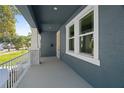 Enjoy the outdoors on this spacious covered front porch with modern railings, and ample natural light at 936 57Th N Ave, St Petersburg, FL 33703