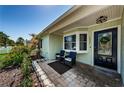 Cozy front porch with comfortable seating, decorative plants, and a stylish entrance door with a wreath at 12901 129Th Ave, Largo, FL 33774