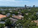 Expansive aerial view of neighborhood with lush greenery, glimpses of Tampa Bay and downtown skyline at 1008 S Armenia Ave # A, Tampa, FL 33629