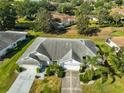 Expansive single-story home with mature trees, lush lawns and a convenient two-car garage at 1016 Mcdaniel St, Sun City Center, FL 33573