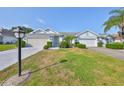 Inviting single-story home featuring a well-kept lawn and a dual garage at 1016 Mcdaniel St, Sun City Center, FL 33573