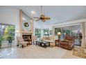 Bright living room features fireplace, seating and lots of natural light at 10321 Shady Oak Ln, Seminole, FL 33777