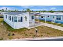A charming single-story home with a seahorse decoration and well-maintained lawn at 119 E Saint Johns Way, Apollo Beach, FL 33572