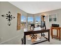 Bright home office space featuring a wooden desk with large windows at 119 E Saint Johns Way, Apollo Beach, FL 33572