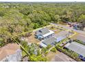 Aerial view of the property highlighting the fenced yard and landscaping in a lush setting at 1322 Idlewild Dr, Clearwater, FL 33755