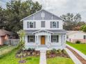 Beautiful two-story home with professionally landscaped yard, stone accents, shutters, and charming front porch at 1526 W Arch St, Tampa, FL 33607