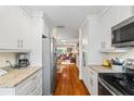 Updated kitchen offering granite counters, stainless appliances, and hardwood floors at 1666 S Lake Ave # 1, Clearwater, FL 33756