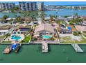 Waterfront property with pool and dock, nestled in a vibrant community with palm trees and stunning bay views at 17 Bellevue Dr, Treasure Island, FL 33706