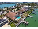 An aerial shot showcases a backyard with a private pool and a waterfront dock at 17 Bellevue Dr, Treasure Island, FL 33706