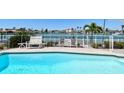 Backyard pool area with patio, fence, seating, and waterfront views at 17 Bellevue Dr, Treasure Island, FL 33706