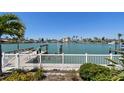 Beautiful waterfront view featuring a private dock, canal and sunny skies at 17 Bellevue Dr, Treasure Island, FL 33706