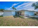 Charming single-Gathering home with stone accents, a manicured front yard, and colorful landscaping at 1710 Hibiscus N Cir, Oldsmar, FL 34677