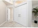 Bright entryway features tile floors, a double front door, and a plant adding a touch of greenery at 1916 Sandstone Pl, Clearwater, FL 33760
