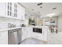 Stylish kitchen with white cabinets, subway tile backsplash, stainless steel appliances, and modern lighting at 1916 Sandstone Pl, Clearwater, FL 33760