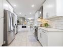 Spacious, updated kitchen with stainless appliances, white cabinetry, and open layout to the dining area at 1916 Sandstone Pl, Clearwater, FL 33760