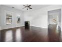 Spacious living area with rich hardwood floors, decorative fireplace, and classic architectural details at 2810 N Jefferson St, Tampa, FL 33602