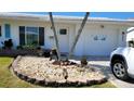 A well-maintained front yard featuring decorative stone accents and lush greenery at 3436 100Th N Ave, Pinellas Park, FL 33782