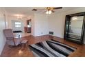 Inviting living room featuring parquet floors, ceiling fan, and seamless access to the kitchen at 3436 100Th N Ave, Pinellas Park, FL 33782
