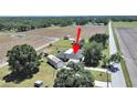 Aerial view of property, highlighting the home's layout with adjacent fields at 3908 N Forbes Rd, Plant City, FL 33565