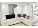 Bright living room with white tile flooring, staircase, and comfy sectional sofa at 5118 Tennis Court Circle, Tampa, FL 33617