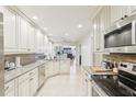 Bright kitchen features white cabinetry, stainless steel appliances, and granite countertops at 5335 Sand Crane Ct, Wesley Chapel, FL 33543