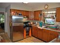 Functional kitchen with stainless steel appliances, wood cabinets, and a practical layout at 601 W College Ave, Ruskin, FL 33570