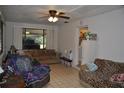 Comfortable living room featuring tile floors, a ceiling fan, and lots of natural light at 601 W College Ave, Ruskin, FL 33570