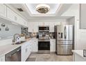 Modern kitchen featuring stainless steel appliances, white cabinets, and stylish backsplash at 6205 Shoreline Dr # 1204, St Petersburg, FL 33708
