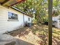 Exterior view of side of home and partially shaded backyard at 6350 55Th N Ave, St Petersburg, FL 33709