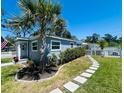Well-maintained home featuring lush landscaping and a charming stone pathway to the front door at 6401 30Th N Way, St Petersburg, FL 33702