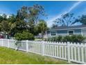 Quaint single-Gathering home surrounded by lush greenery and a classic white picket fence at 6401 30Th N Way, St Petersburg, FL 33702