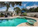 Inviting backyard pool area with stone patio, lush landscaping, and stylish patio furniture, perfect for outdoor entertaining at 8054 38Th N Ave, St Petersburg, FL 33710