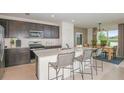 Bright, open kitchen with a large island, stainless steel appliances, and a view of the water at 9959 Trellis Vine Way, Parrish, FL 34219