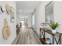 Inviting hallway showcasing wood floors and an open layout leading to the dining and living areas at 1004 Spotted Egret Loop, Ruskin, FL 33570