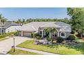 Charming home boasts lush landscaping, a paved driveway, and a welcoming entrance, creating a delightful curb appeal at 1307 Forestedge Blvd, Oldsmar, FL 34677