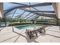 A screened-in pool and patio offer a private oasis for relaxation and entertaining, perfect for enjoying outdoor living at 1307 Forestedge Blvd, Oldsmar, FL 34677