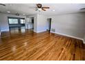 Open-concept floor plan with hardwood floors connecting to the kitchen at 1417 W Curlew Pl, Tarpon Springs, FL 34689